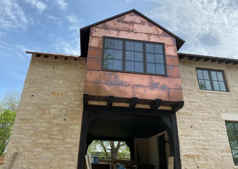 Copper metal panel facade on a stone building for Skylight Installation in Herrin